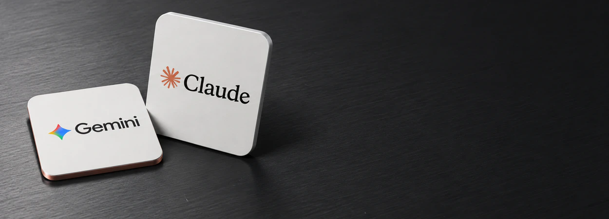 Claude and Gemini subscription cards on a desk